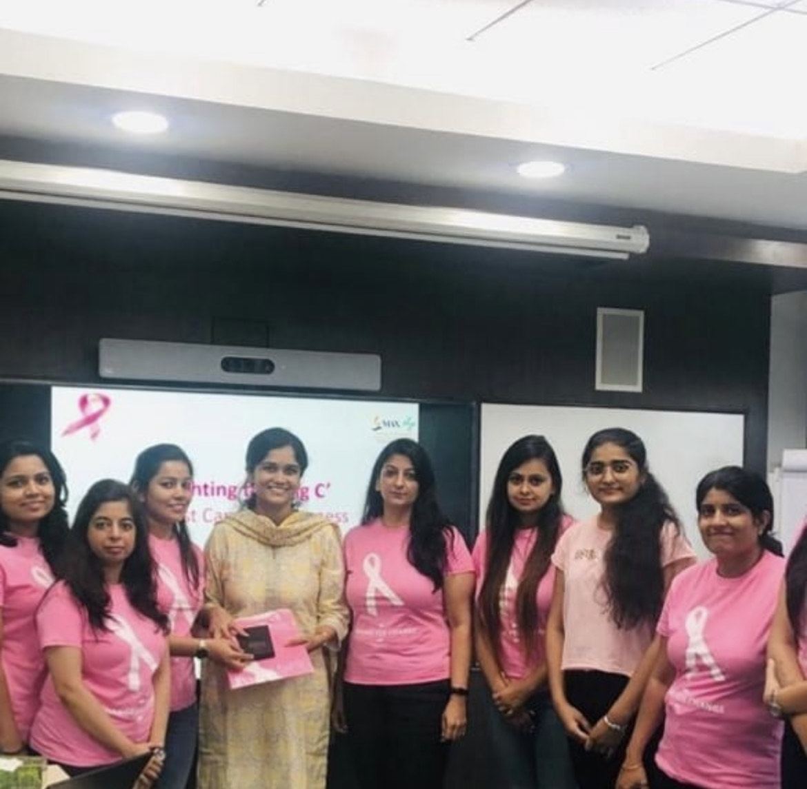 Dr Aditi Chaturvedi with participants at a pink-ribbon breast cancer awareness session